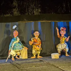 Three characters from one of our productions, showcasing the expressive faces and detailed costumes of our string puppets. Each puppet is manipulated with skill to portray complex characters and emotions from our ancient texts.