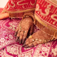 The final stain is so important, and I'm proud of the deep, dark color my organic henna produces. This is how beautifully the mehndi contrasts with a traditional red bridal lehenga, perfect for all your wedding photos.