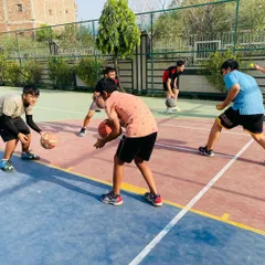 Players engaged in a stationary dribbling drill, focusing on ball control and keeping their eyes up.