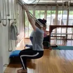 Using the wall ropes for support in this seated pose allows the student to lift and open the chest and shoulders. This is crucial for creating space for the lungs and heart, which is the foundation of good health and energy.
