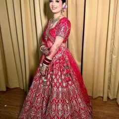 Simply enchanting. This bride glows in her beautiful red and silver lehenga, with a soft glam makeup look that enhances her smile.