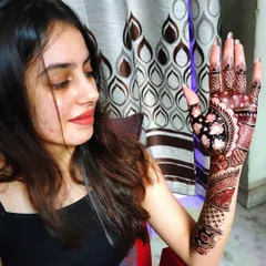 A happy client showing her beautiful back-hand design. The dark, rich stain looks perfect for her event.