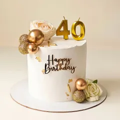 An elegant 40th birthday cake in white and gold. This design features fresh roses, gold chocolate spheres, and delicate gold leaf accents for a touch of luxury.
