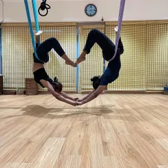 Aerial yoga is a beautiful way to build trust and find harmony with a partner. Here, we are creating a heart shape with our bodies, suspended in the air. It’s a practice of love, for yourself and for each other.