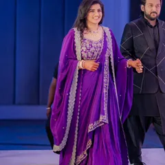 For a formal reception, we decided to customize this beautiful purple draped outfit. The lightweight fabric and elegant drapes were designed to flatter the bride's body type while allowing her to move comfortably.