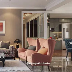 This view showcases how we connect different zones in an open-plan layout. The living area flows seamlessly into the kitchen and dining spaces, unified by a consistent color palette and elegant design choices like the blush wingback chairs.