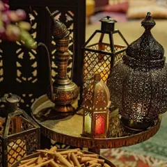 A collection of authentic Moroccan lanterns and a traditional teapot, used as decor elements to enhance the theme. These details are crucial for creating a truly believable and immersive experience.