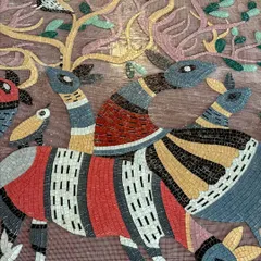 A close-up of a glass mosaic mural inspired by Gond art. Each piece of glass is hand-cut and placed to create a vibrant, textured narrative of deer and birds in an enchanted forest.