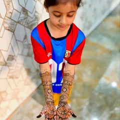 Even the little ones can join in. Here is a full, detailed mehendi design for a 6-year-old, personalized with her brother's name, "Zohan."