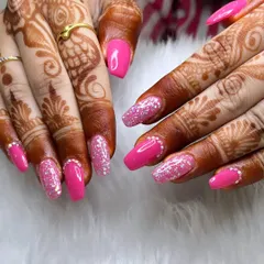 Perfect for a bride or any special occasion, this manicure pairs bright pink nails with full-coverage silver glitter accent nails. The look is further enhanced by tiny rhinestones at the cuticle line.