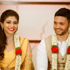 The prettiest bride, Shrusti, with her husband on their special day. She is wearing a vibrant yellow modern gown with cold-shoulder sleeves featuring delicate gold embroidery.