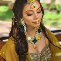A beautiful shot of the model with her eyes closed, showing off the vibrant makeup that pairs perfectly with this festive outfit.
