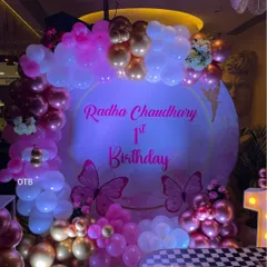 The personalized backdrop with butterfly details looks so pretty under the party lights. I can customize the text with your baby's name and birthday message.