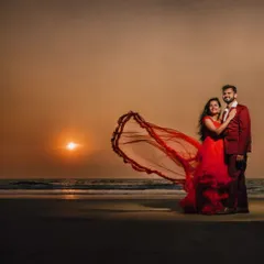 A breathtaking sunset beach photo. This couple rented a matching red gown and suit from my collection to create this incredibly romantic and cinematic pre-wedding shot.