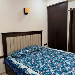 The master bedroom in the 2BHK apartment, featuring a custom bed and matching wardrobe.
