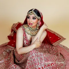 This traditional bridal look combines modern techniques with classic aesthetics. The focus is on dramatic eyes and radiant skin, creating a perfect portrait for the bride who is both traditional and contemporary.