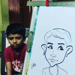 A quiet moment of concentration. This young boy is watching intently as I create his portrait right next to him.