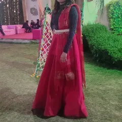Our client enjoying an outdoor wedding event in a rented red lehenga skirt. This fusion look is perfect for a mehndi or sangeet party.