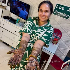 Happy client Roopal Tyagi showing off her beautiful mehendi. The design tells the story of her journey, and the stain is a testament to the quality of the paste.