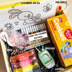 Our 'Rakhi Dhamaka' hamper for kids is full of fun! It includes a DIY coloring pouch with markers, cookies, toffee-shaped highlighters, a cute rakhi, and sanitizer.