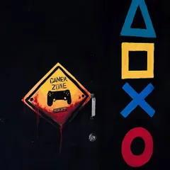 I also paint smaller elements to complete a theme. This "Gamer Zone" sign and PlayStation symbols were painted on the door, setting the tone for the room before you even step inside.