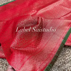 Here is the full view of this stunning red Banarasi silk saree with a contrasting green border. The pallu is heavily woven with traditional motifs.