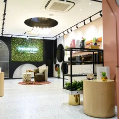 We designed this skincare store in Delhi with a fresh, modern, and feminine aesthetic. The space combines soft pastel pinks, terrazzo flooring, a living green wall with a neon sign, and natural wood displays to create a welcoming brand experience.