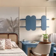 This bedroom corner features a study nook in a calm, muted blue, providing a gentle contrast to the room's warm tones. The design is a perfect blend of function and flow, ideal for focus and creative work.