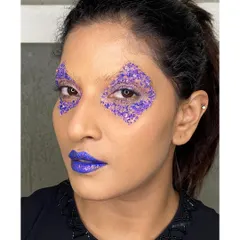 Creating sharp, geometric shapes with glitter is one of my favorite techniques for an edgy editorial concept. Here, I used purple glitter to craft a diamond shape around the eye, paired with a bold purple lip.