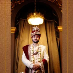 A classic portrait of the groom in his majestic wedding sherwani and turban, ready for the main event.