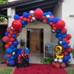 A Spider-Man themed balloon arch at the entrance of a home, creating a grand welcome for a 2nd birthday party.