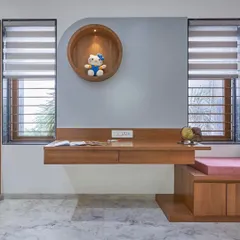 A clever and compact study nook designed for a child's room. The floating wooden desk is paired with a circular, lit display shelf, creating a functional and inspiring space for homework and creativity.