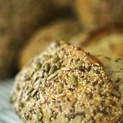 A detailed shot of our multi-seed bread, showcasing the generous coating of sunflower, pumpkin, and sesame seeds. It's as nutritious as it is delicious.