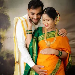 A classic South Indian maternity portrait. The couple's coordinated traditional outfits and the tender poses beautifully honor their cultural roots.