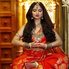 A serene, meditative pose of the Devi look, with a close-up on the intricate details of the necklace, nose ring, and the third-eye bindi.