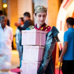 A costumed host delivering gift boxes at a princess-themed birthday party, showing how I can add an element of surprise and theater to your events.
