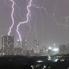 A closer crop of the storm, focusing on the intricate patterns of lightning striking between the city's high-rise buildings. Each bolt tells a different story.