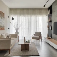 This living room is a study in calm. The neutral palette, from the boucle sofa to the textured walls and sheer curtains, creates a serene backdrop. The clean lines of the oak coffee table and armchair add a touch of modern residential design.