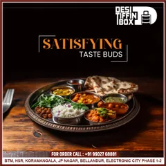 A traditional North Indian thali served on a classic steel plate. This meal includes rice, multiple curries, dal, and roti, perfectly arranged to satisfy your taste buds and remind you of home.