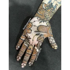 A custom design for Diwali. This piece has a modern feel, with abstract floral and leaf patterns that flow diagonally across the hand. It shows how versatile henna can be.