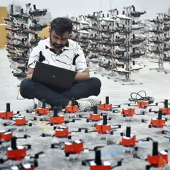 Every show begins with meticulous planning and programming. Here, one of our engineers is surrounded by our drone fleet, fine-tuning the choreography for a large-scale performance. This level of precision ensures every drone moves in perfect harmony.