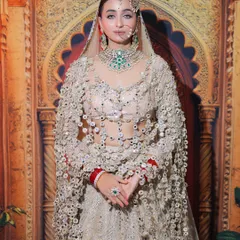 The full view of this stunning bride in her unique mirror-work lehenga. The makeup is kept clean and regal to complement the intricate outfit.