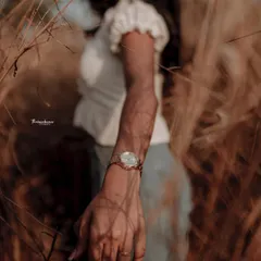 A creative detail shot focusing on the watch, with the model blurred in the background. This is a great way to highlight an accessory in a lifestyle context.