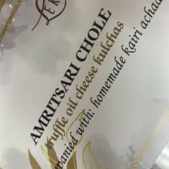 The star of the dish: Amritsari Chole with Truffle Oil Cheese Kulchas. The menu card highlights the unique fusion of traditional Punjabi flavors with a gourmet touch.