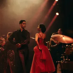 A candid moment between the lead dancers for the Origin & Ode campaign. The styling, with the vibrant red dress and classic menswear, was chosen to evoke a timeless, romantic feel.