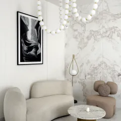 This cozy seating area in the daughter's bedroom feels both elegant and inviting. The soft pink and white interiors, curved sofas, and custom-made beaded chandelier add a touch of charm and femininity to the room.