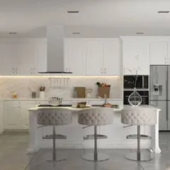 This luxurious all-white island kitchen is the epitome of timeless elegance. The design includes a breakfast counter with plush seating, extensive cabinet storage, and integrated high-end appliances, creating a bright and sophisticated culinary hub.