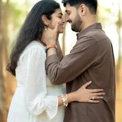 An intimate close-up showing the couple's deep affection. The way they look at each other, nose to nose with gentle smiles, tells a story of shared love and excitement for their growing family.