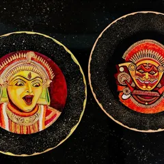 A pair of wall plates depicting faces from Bhoota Kola and Theyyam, two powerful folk ritual dances. Each plate captures a different character and expression, representing a deep connection to the spiritual world.