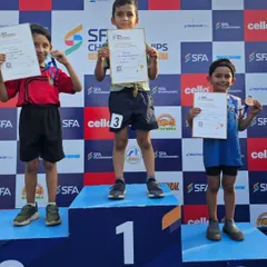 One of our youngest athletes stands proudly on the winner's podium. Our program is designed to introduce children to competitive sports in a positive and encouraging way.